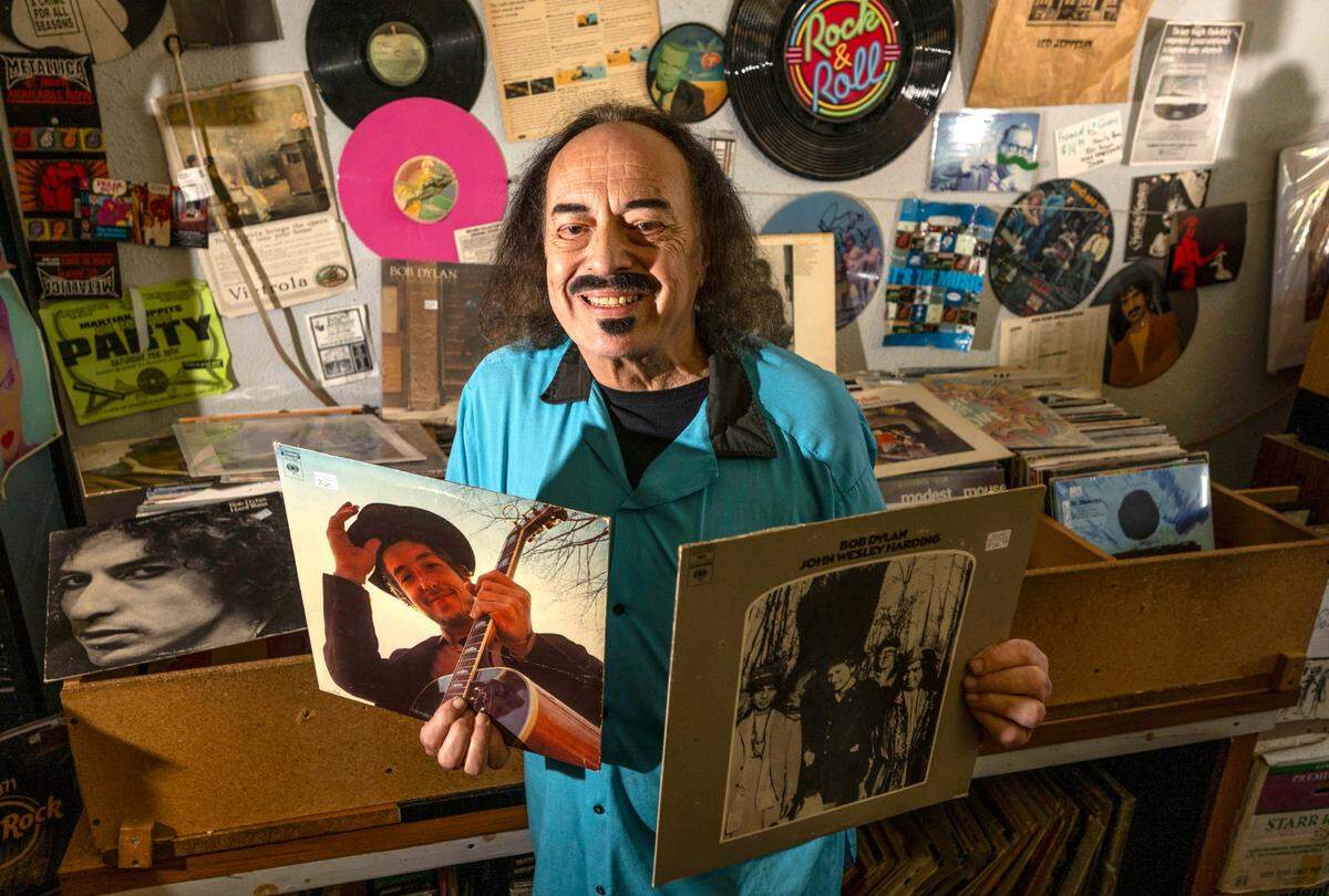 Sound Attitude record store owner Bert Angelisi holds some of the records by Bob Dylan on Thursday, May 8, 2025, in Yuba City. Dylan and Willie Nelson will be playing in Wheatland on Sunday.