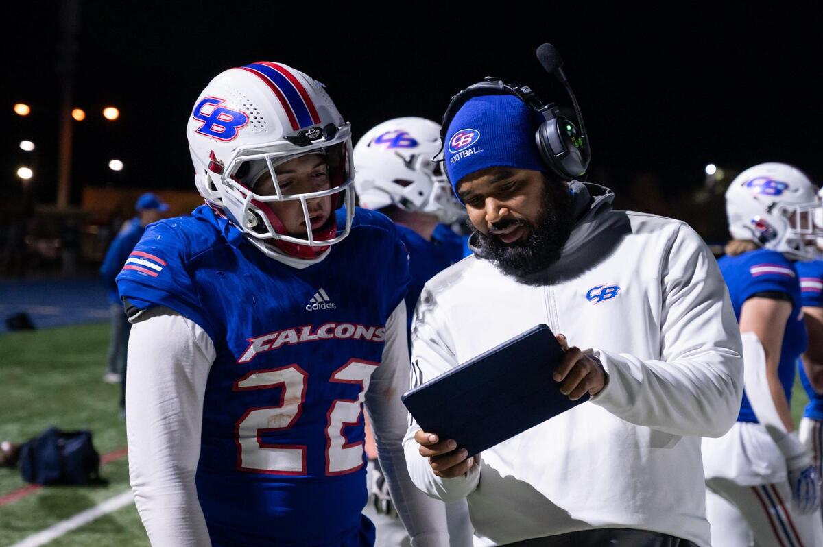 Christian Brothers Falcons coach Larry Morla talks with Landon Howard (22) on the sidelines during the second half in the CIF Sac-Joaquin Division III semifinal playoff game Friday, Nov. 18, 2022, at Christian Brothers High School in Sacramento. The Falcons won 20-14.
