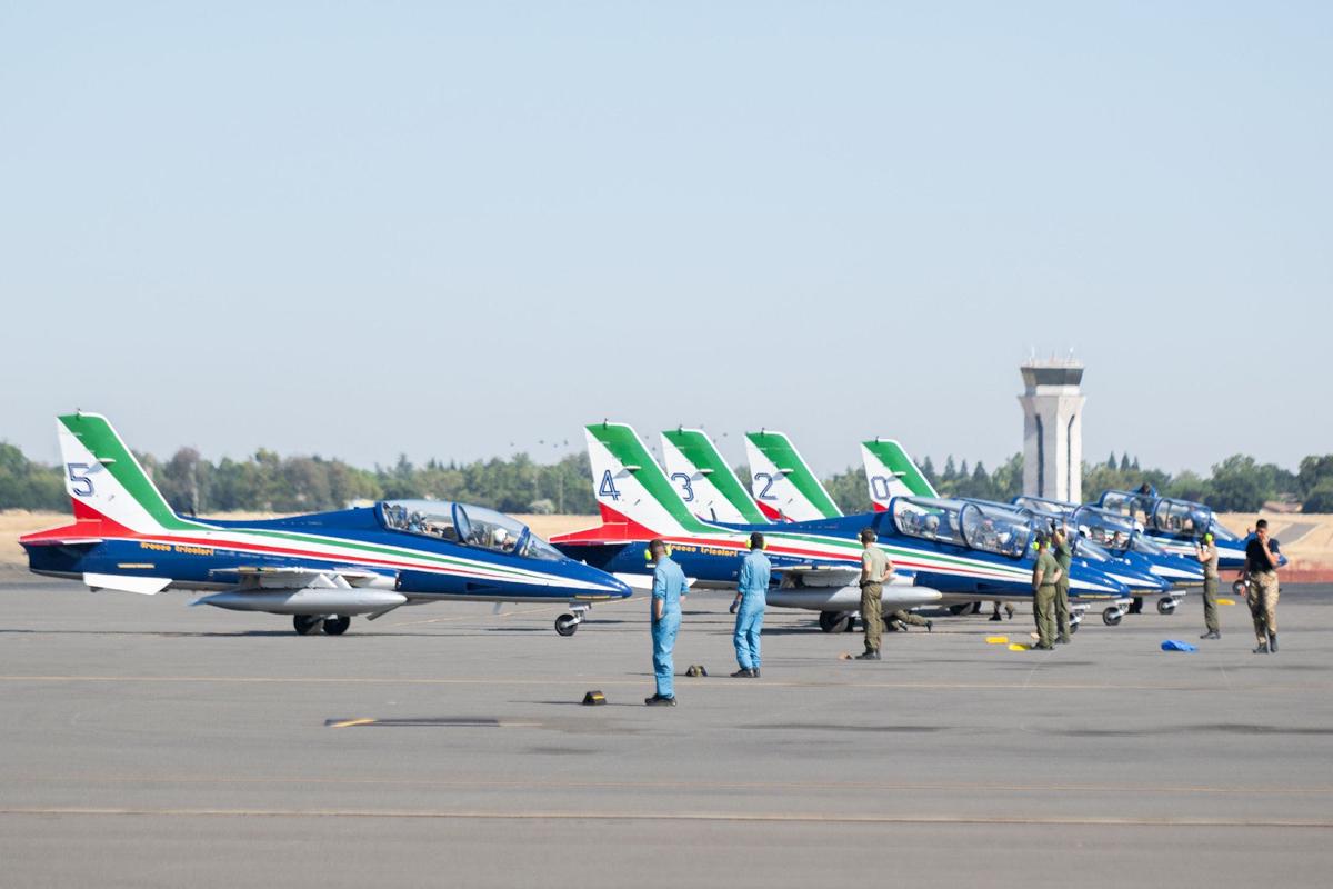 Pilots of Frecce Tricolori, the Italian air force’s aerobatic team, park their jets at Mather Airport near Rancho Cordova on Tuesday. A crowd of onlookers greeted them with cheers and applause upon their landing. The team is performing in the California Capital Airshow for the first time.