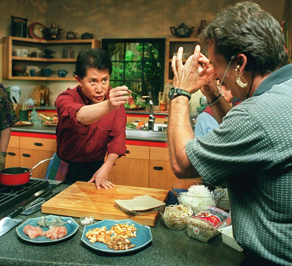 Cookbook author and TV chef Martin Yan does a dry run to check on camera angles before the taping of a segment of his new cooking show series at the KVIE studio in Sacramento 5/30/2000. In the show he likes to interact with the audience by speaking directly to the camera; in this case he is asking them to taste some Thai tea. (Sacramento Bee/ Leilani Hu )