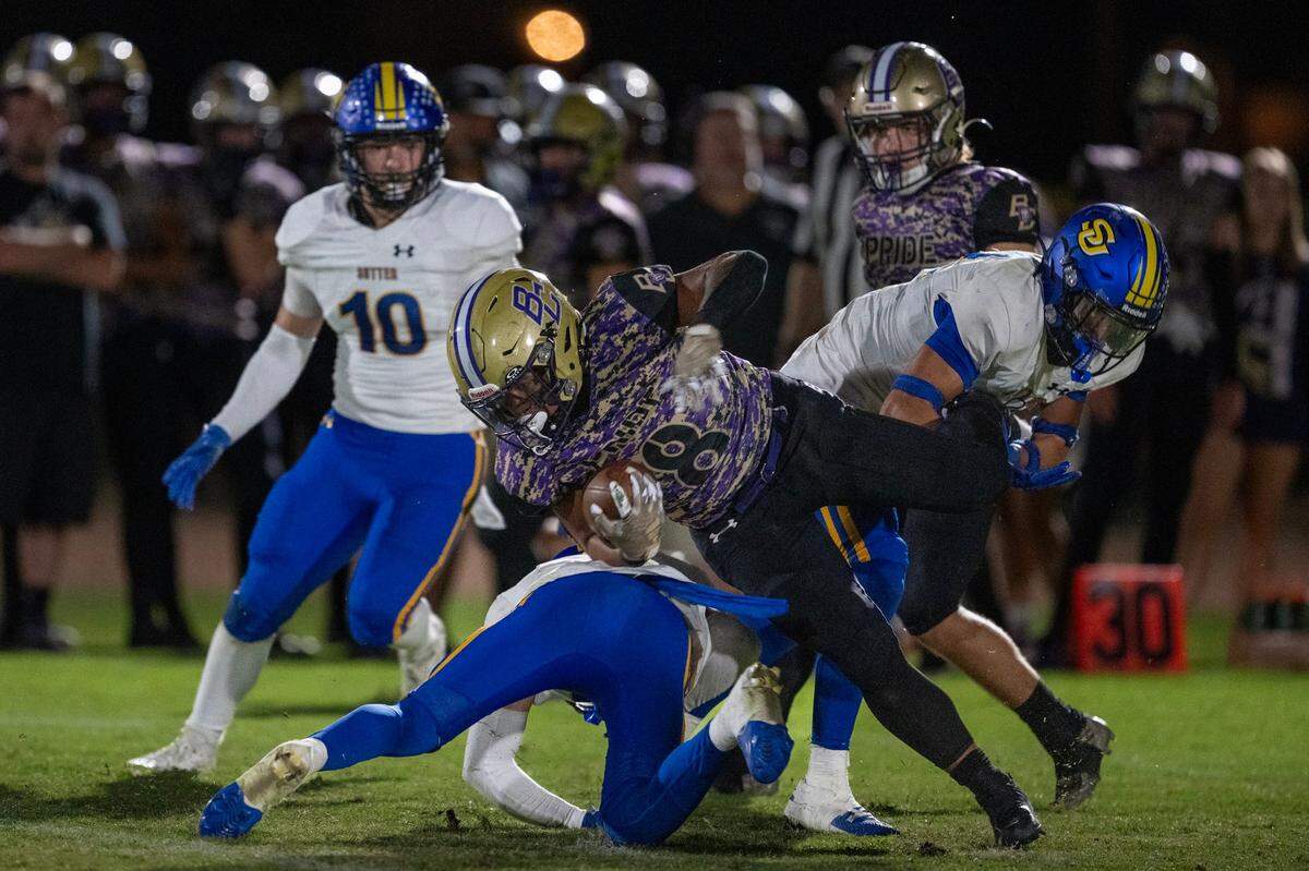 The Bradshaw Christian Pride’s Mateo Mojica (8) is tackled by the Sutter Huskies’ Ezra Hilleary (18) in the second half on Friday at Bradshaw Christian High School.