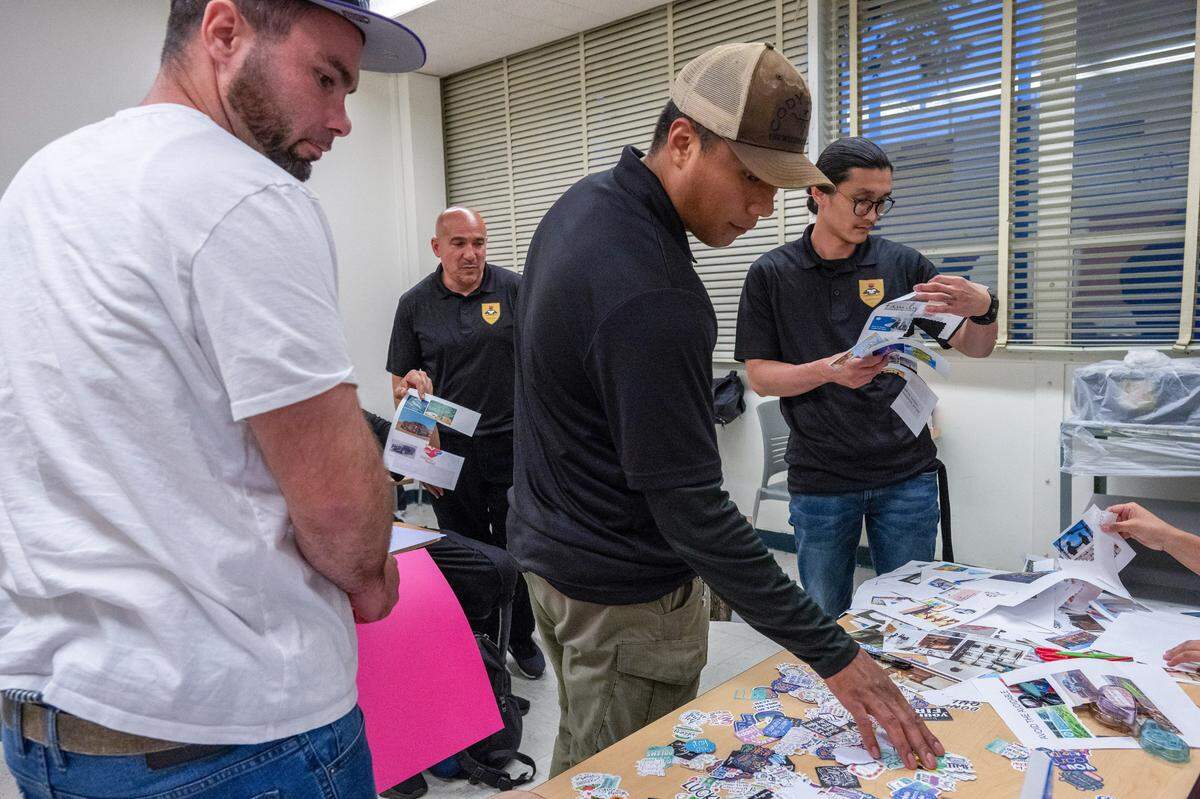 Ex-offenders Daniel Russell, left, Angel Cruzata, back, Alfredo “Pasta” Ochoa and Anh-Tuan Pham, right, collect artwork to create vision board collages during the Reintegration Academy session at Sacramento State on May 2. The students participated in an eight-week program focused on life skills, career development and vocational education.