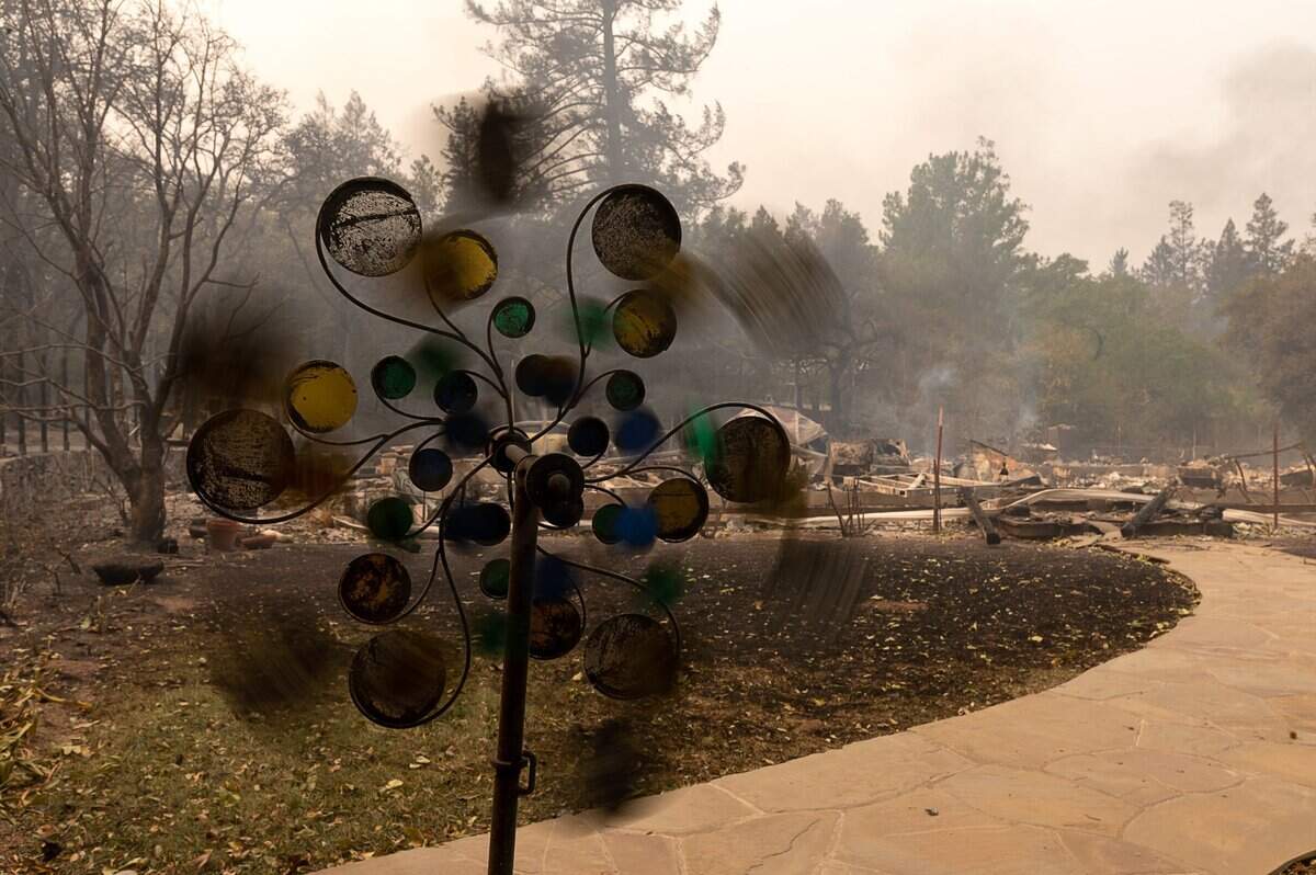 A wind mobile spins in front of a home destroyed during the Glass Fire off of Sunnyside Road on Monday, Sept. 28, 2020 in St. Helena.