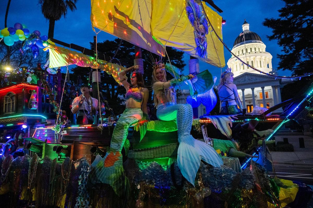 Mermaids ride a pirate ship past the state Capitol in the City of Trees Parade to celebrate Mardi Gras on Saturday.