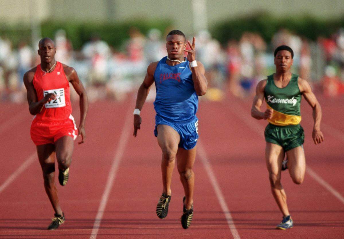 Albert Hollis, center, of Christian Brothers, wins the varsity men’s 100-meter dash during the Sacramento Meet of Champions Open / Invitational Sessions at Hughes Stadium on Saturday, May 8, 1999.