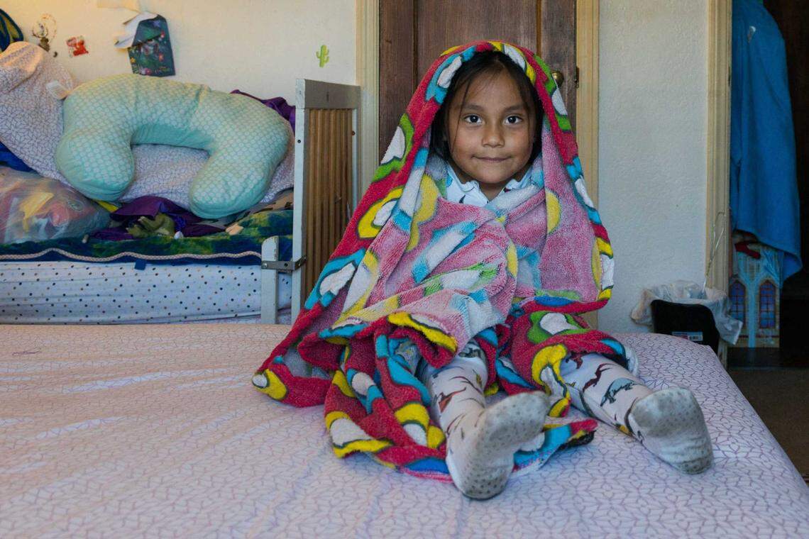 Erandy Bravo sits wrapped in her baby blanket in August. It’s the only possession the Bravo family was able to save the night of the fire.