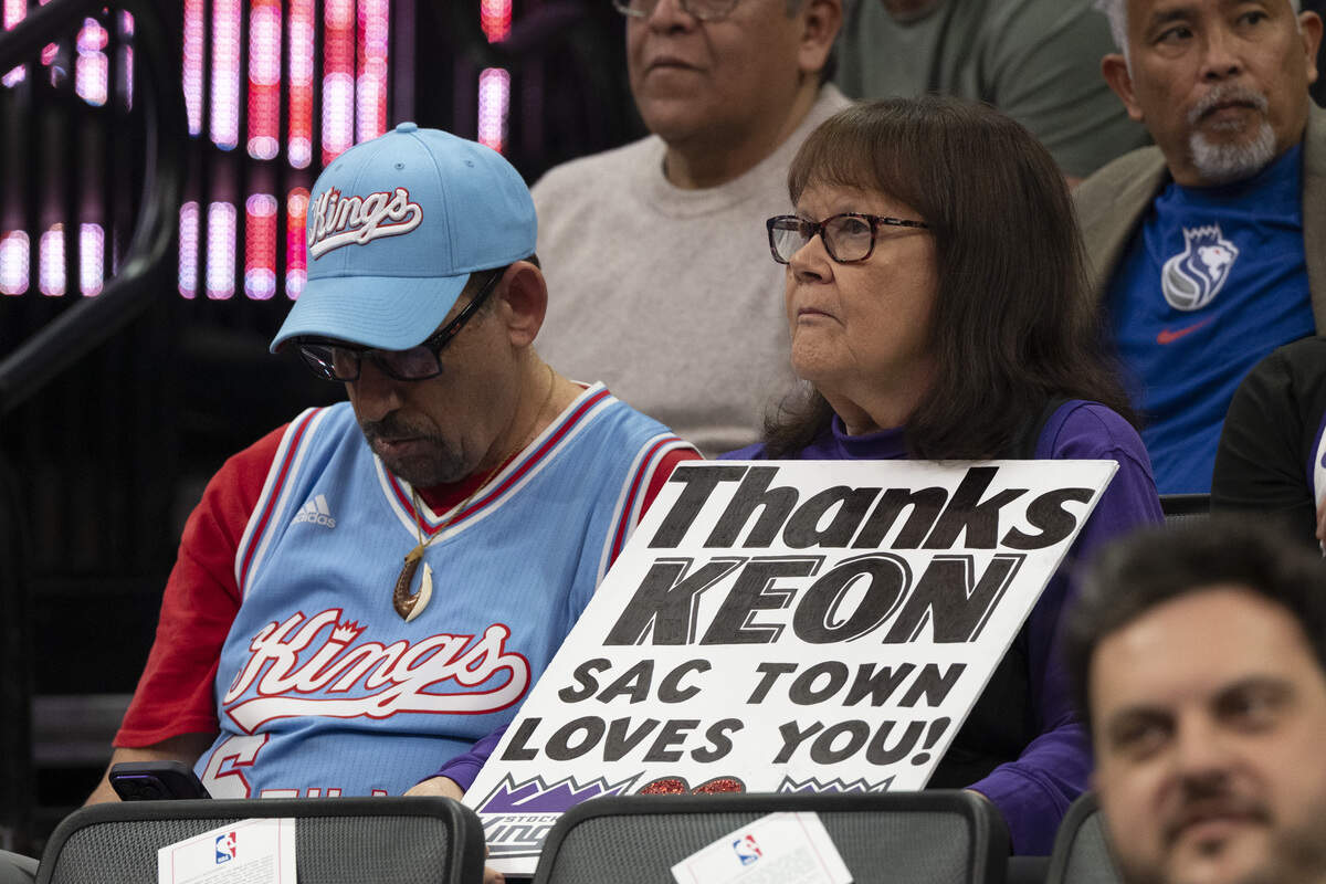 Fans hold signs in honor of Cleveland Cavaliers guard Keon Ellis (14) during a game at Golden 1 Center in Sacramento on Saturday. Ellis was traded to the Cavs from the Kings.