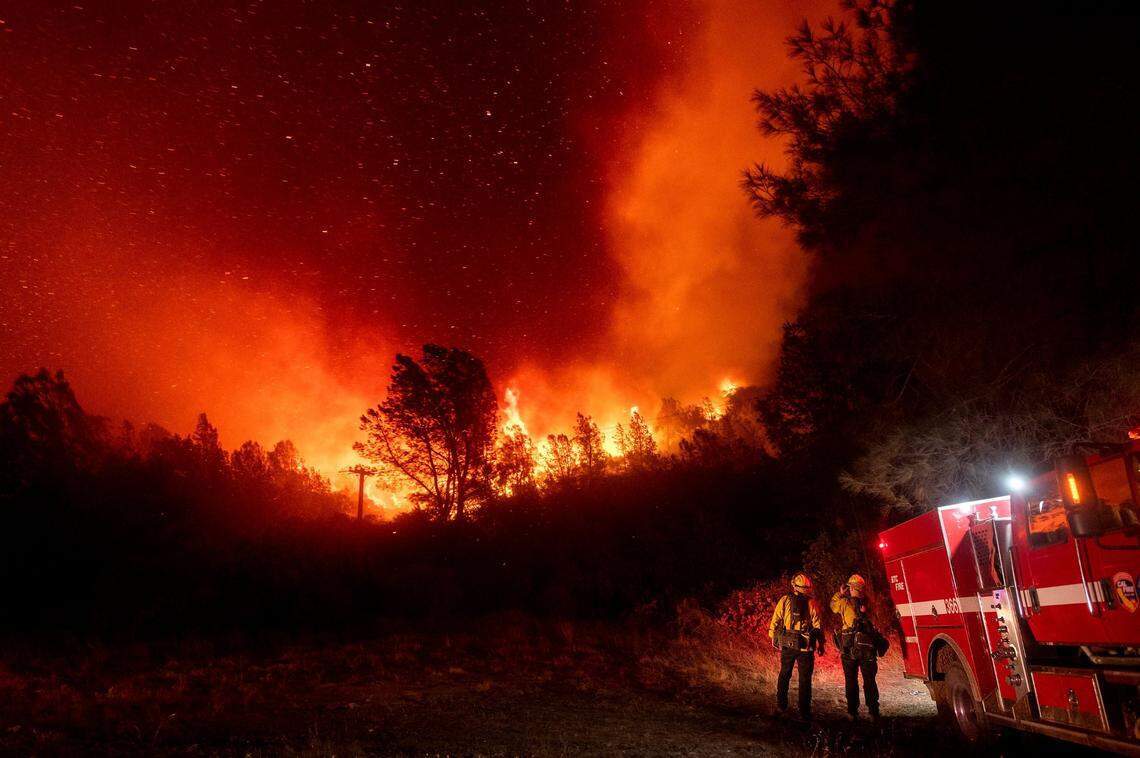 Firefighters watch the Bear Fire approach near Oroville, Calif., on Wednesday, Sept. 9, 2020. The blaze, part of the lightning-sparked North Complex, expanded at a critical rate of spread as winds buffeted the region.