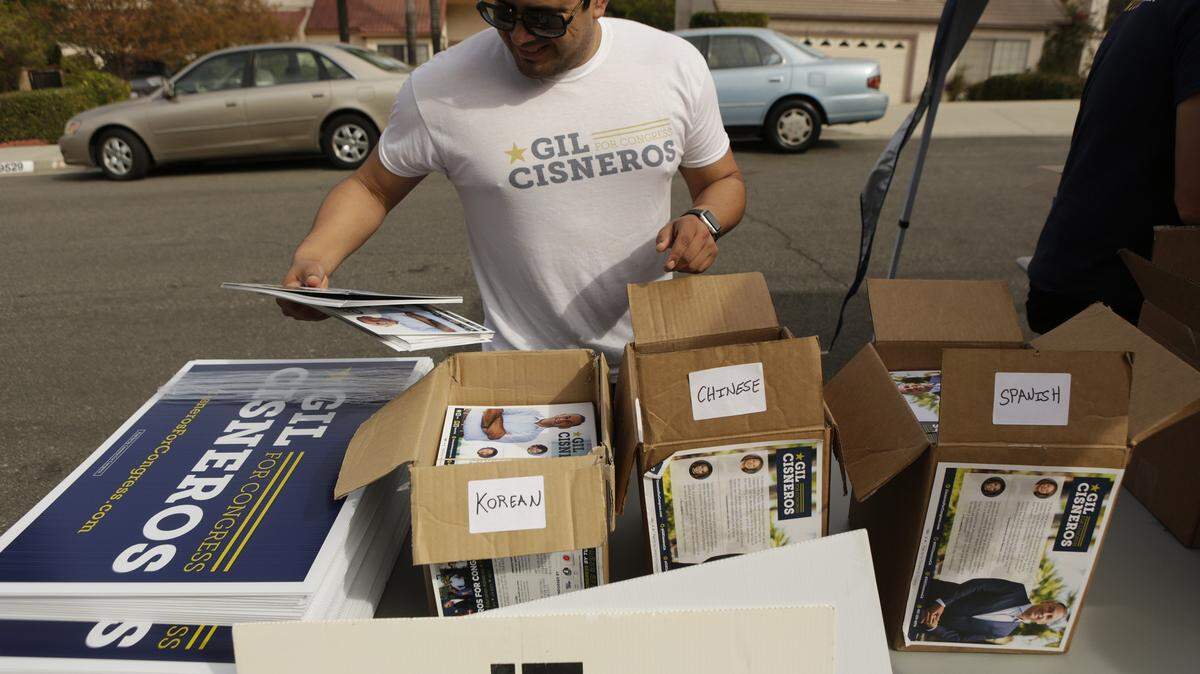 A campaign volunteer for Democrat Gil Cisneros organizes flyers for Cisneros’ effort to mobilize and turn out Asian American voters in the California’s 39th District, a congressional district with a large Latino population  on Oct. 28.