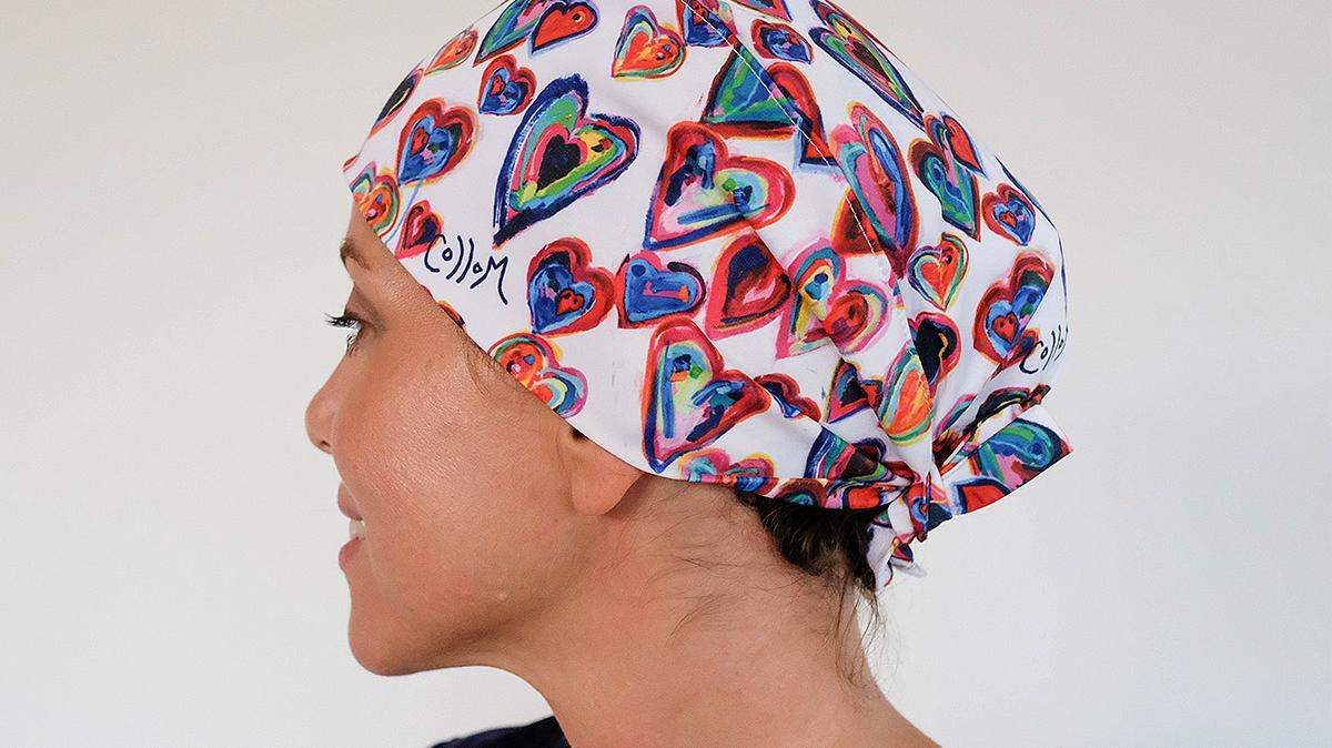 Selena Srabian models a scrub hat produced by Protect With Heart. The group is raising money to provide the PPE to healthcare workers for free.