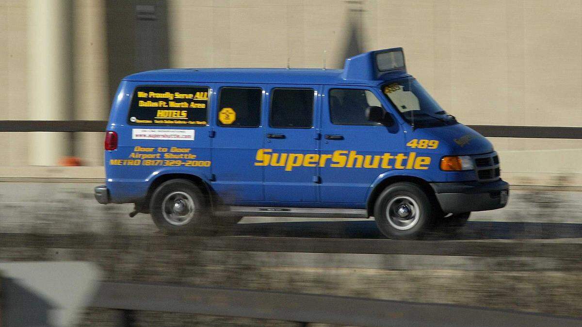 FILE -- The blue and yellow SuperShuttle is seen at Dallas/Fort Worth International Airport in 2004. The company suspended operations at Sacramento International Airport in late 2019 but could return in mid-2021 under new ownership.