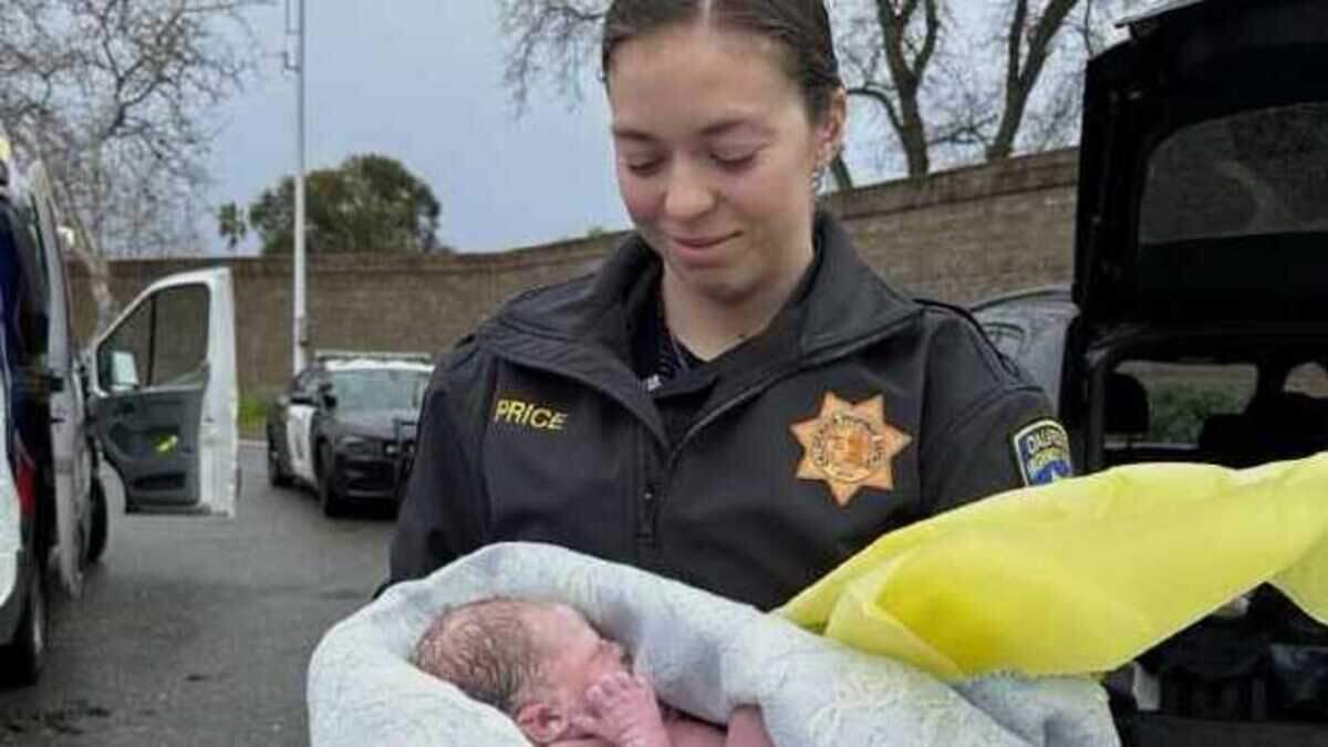 Officer Katie Price helps a mother give birth Saturday on the side of Sacramento’s Interstate 80.