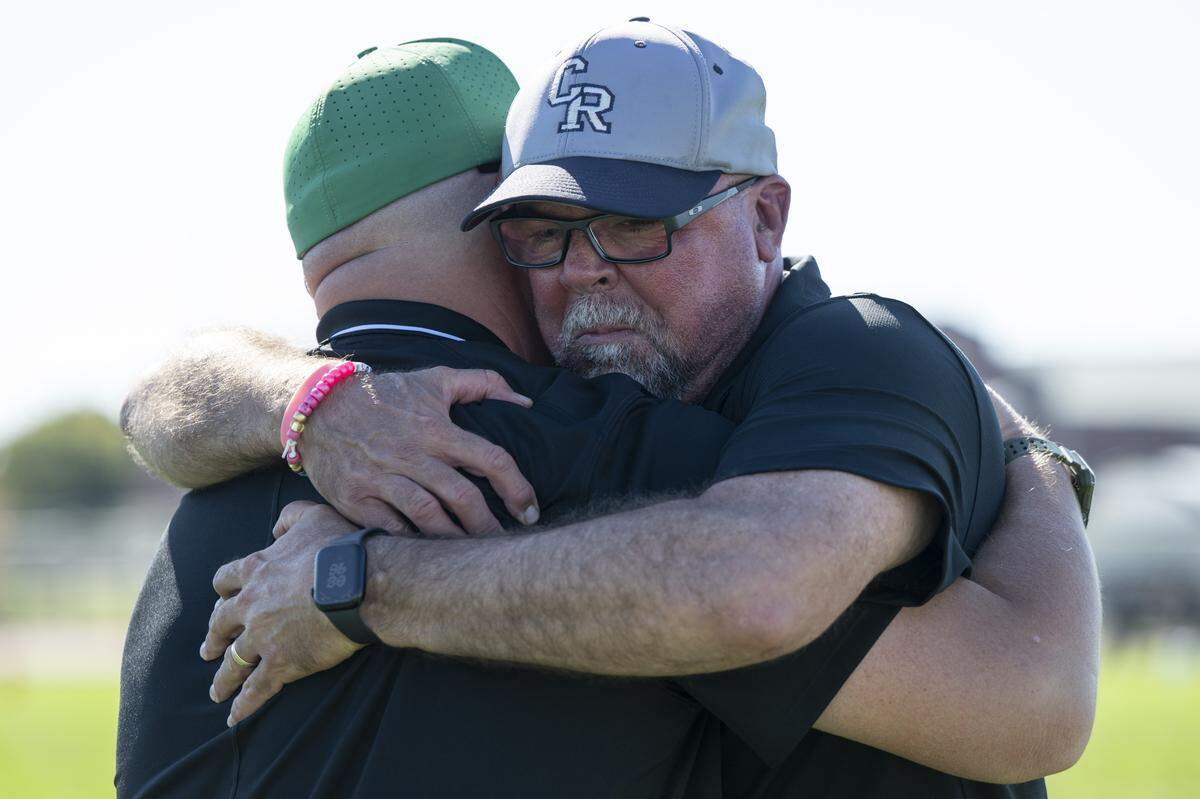 Casa Roble coach Chris Horner, right, tears up as he embraces Dixon coach Wes Besseghini, left, after a game in Dixon between the two teams on Saturday. The game follows the death of one of Dixon’s junior varsity football players.