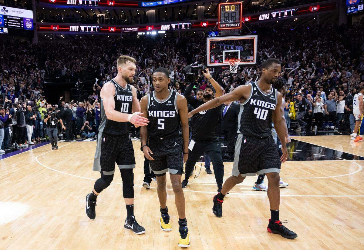 Sacramento Kings center Domantas Sabonis (10, guard De’Aaron Fox (5) and forward Harrison Barnes (40) walk off the court after their victory during Game 2 of the first-round NBA playoff series at Golden 1 Center on Monday, April 17, 2023.