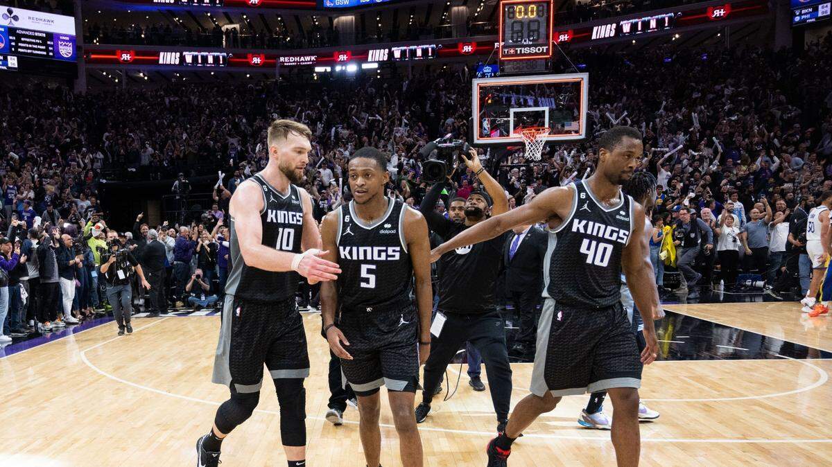 Sacramento Kings center Domantas Sabonis (10, guard De’Aaron Fox (5) and forward Harrison Barnes (40) walk off the court after their victory during Game 2 of the first-round NBA playoff series at Golden 1 Center on Monday, April 17, 2023.
