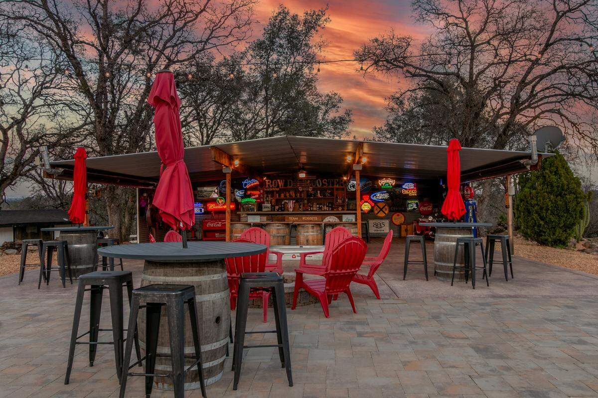 A charming full bar with seating, heating, music speakers and places to dance sits at the back of the property.