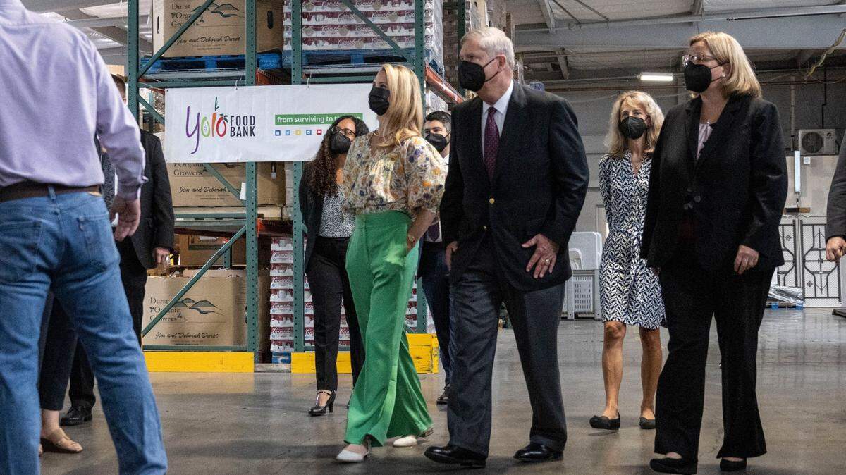 California First Partner Jennifer Siebel Newsom and U.S. Agriculture Secretary Tom Vilsack tour the Yolo Food Bank in Woodland on Wednesday. Vilsack announced the federal government would spend $43 million to purchase and distribute locally grown food from California’s underserved farmers and producers.