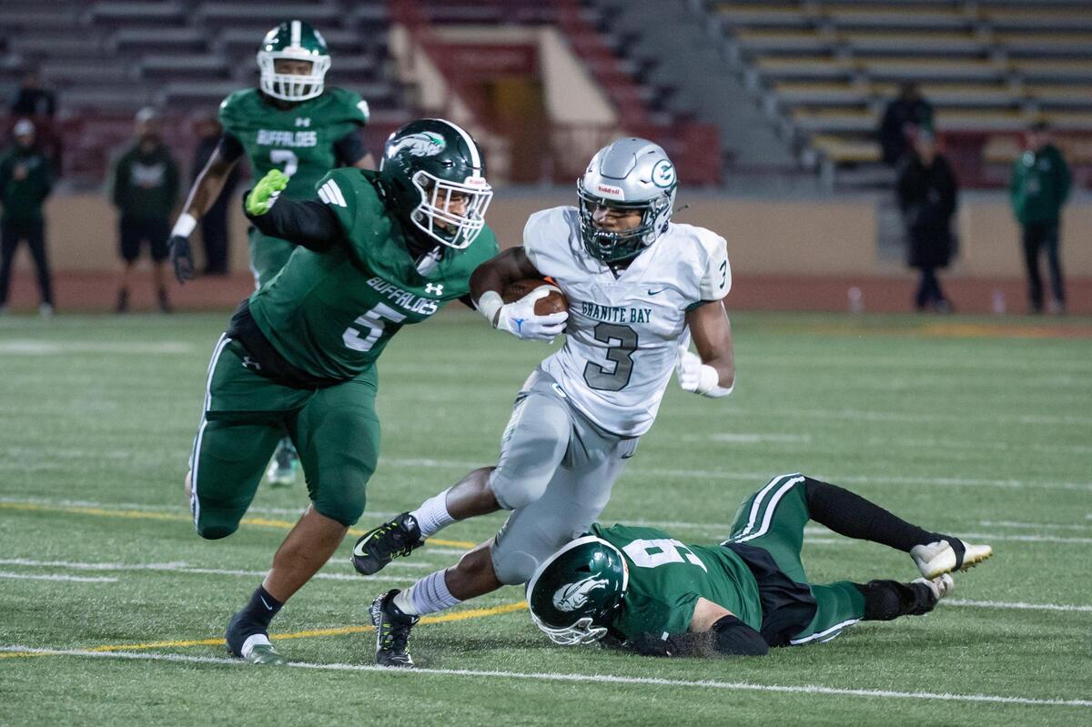 Granite Bay Grizzlies running back Carter Jackson (3) rushes for a first down before being tackled by Manteca Buffaloes Alijah Cota (5) during the third quarter in the CIF Sac-Joaquin Section Division II championship game Saturday, Nov. 26, 2022, at Hughes Stadium at Sacramento City College. The Buffaloes won 51-48.