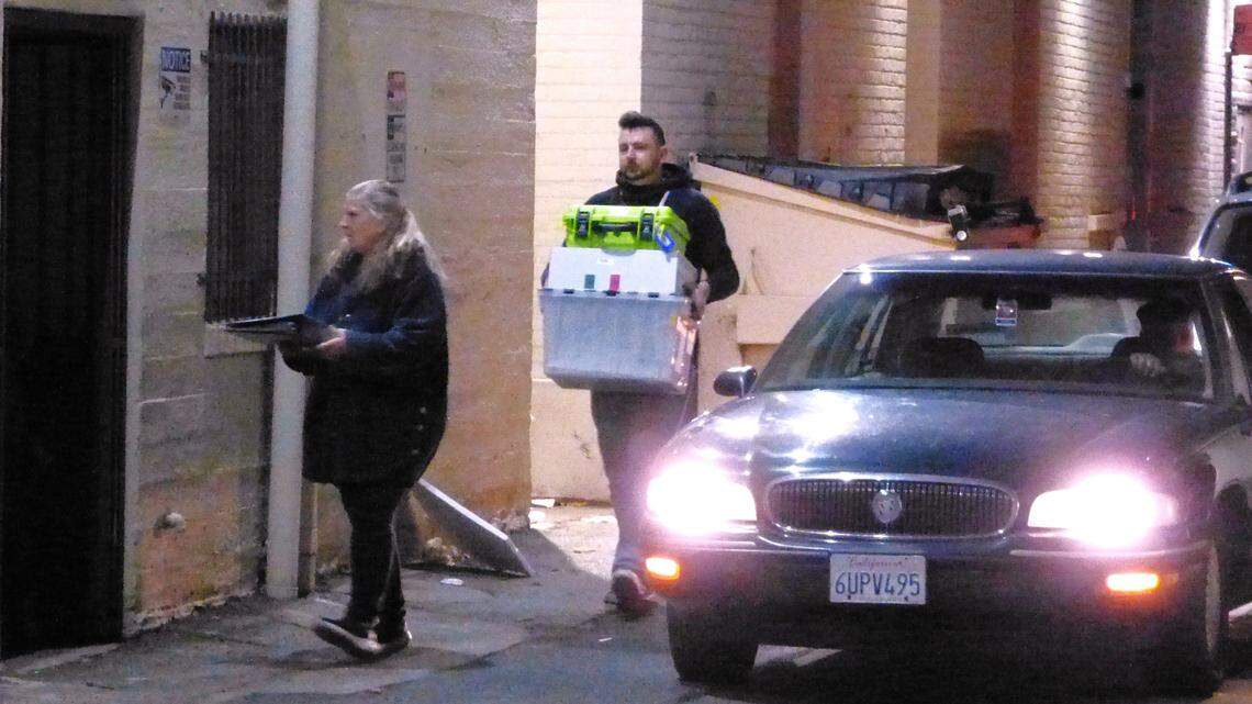 Elections workers carry boxes of ballots delivered from precincts into the Shasta County Elections Office on Tuesday night.