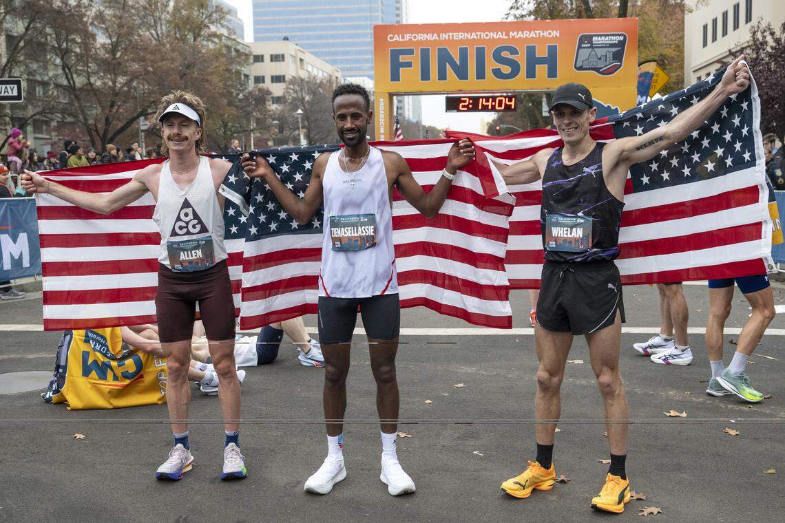 The mens division’s top three finishers, Futsum Zienasellassie, center, Joseph Whelan, right, and Christian Allen pose after winning the California International Marathon in Sacramento on Sunday, Dec. 7, 2025.