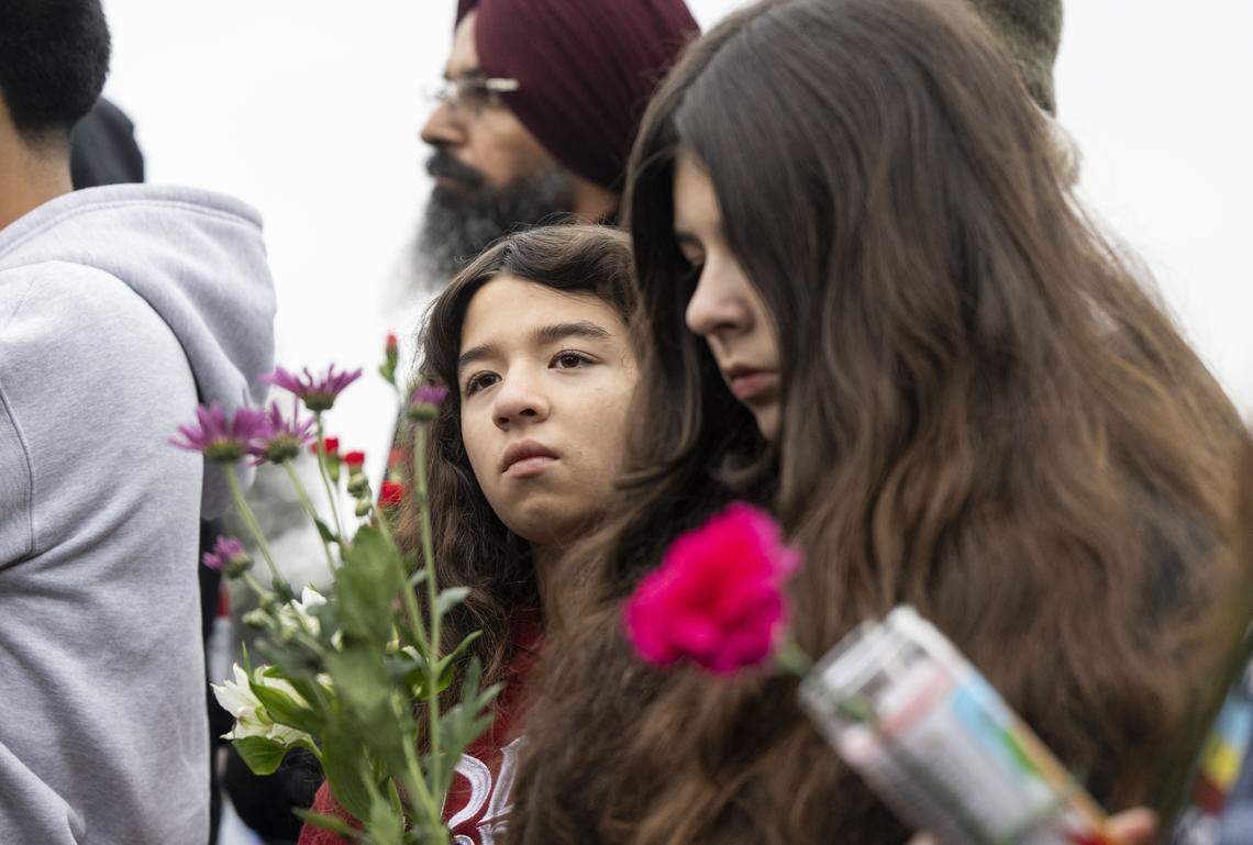Alicia Pinto, 12, and her sister Alizabeth, 13, of Stockton attend a vigil on Sunday, Nov. 30, 2025, for the four people killed and 11 injured after a mass shooting near Stockton.