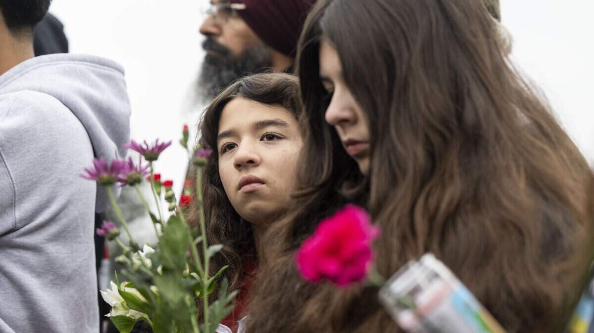 Alicia Pinto, 12, and her sister Alizabeth, 13, of Stockton attend a vigil on Sunday, Nov. 30, 2025, for the four people killed and 11 injured after a mass shooting near Stockton.
