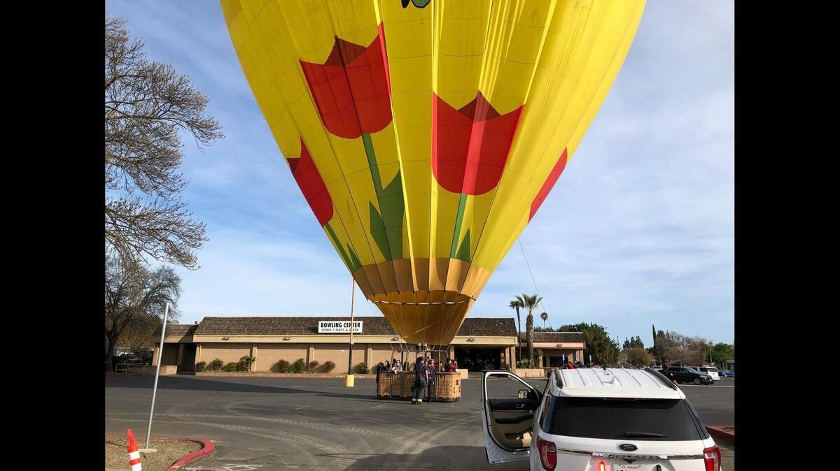 A hot air balloon made an “unexpected” landing in front of a bowling alley on West Main Street on Woodland on Friday, March 6, 2020. No one was hurt, police and fire officials said.