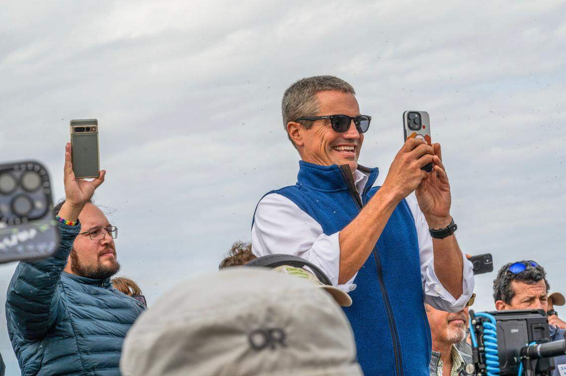 California Natural Resource Agency Secretary Wade Crowfoot takes video during the Lookout Slough levee breaching ceremony on Wednesday, Sept. 18, 2024. An excavator breached the eastern levee allowing tidal water onto the site for the first time in 100 years.