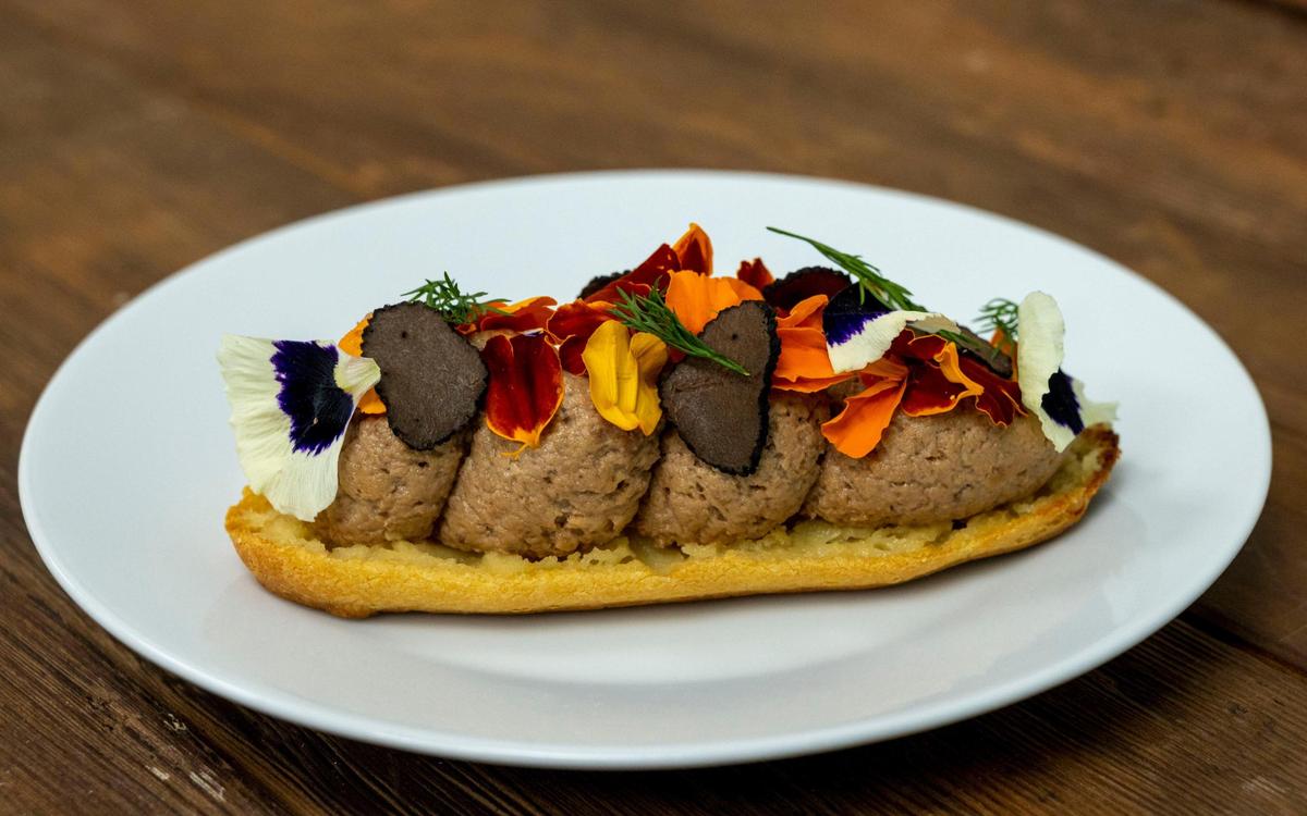A rhiza-based foie gras eclair with truffle shavings and edible flowers is made by The Better Meat Co.’s in-house chef Jared Goldstein on Feb. 24. It’s near in taste, and no ducks or geese are force-fed in the making of the product.