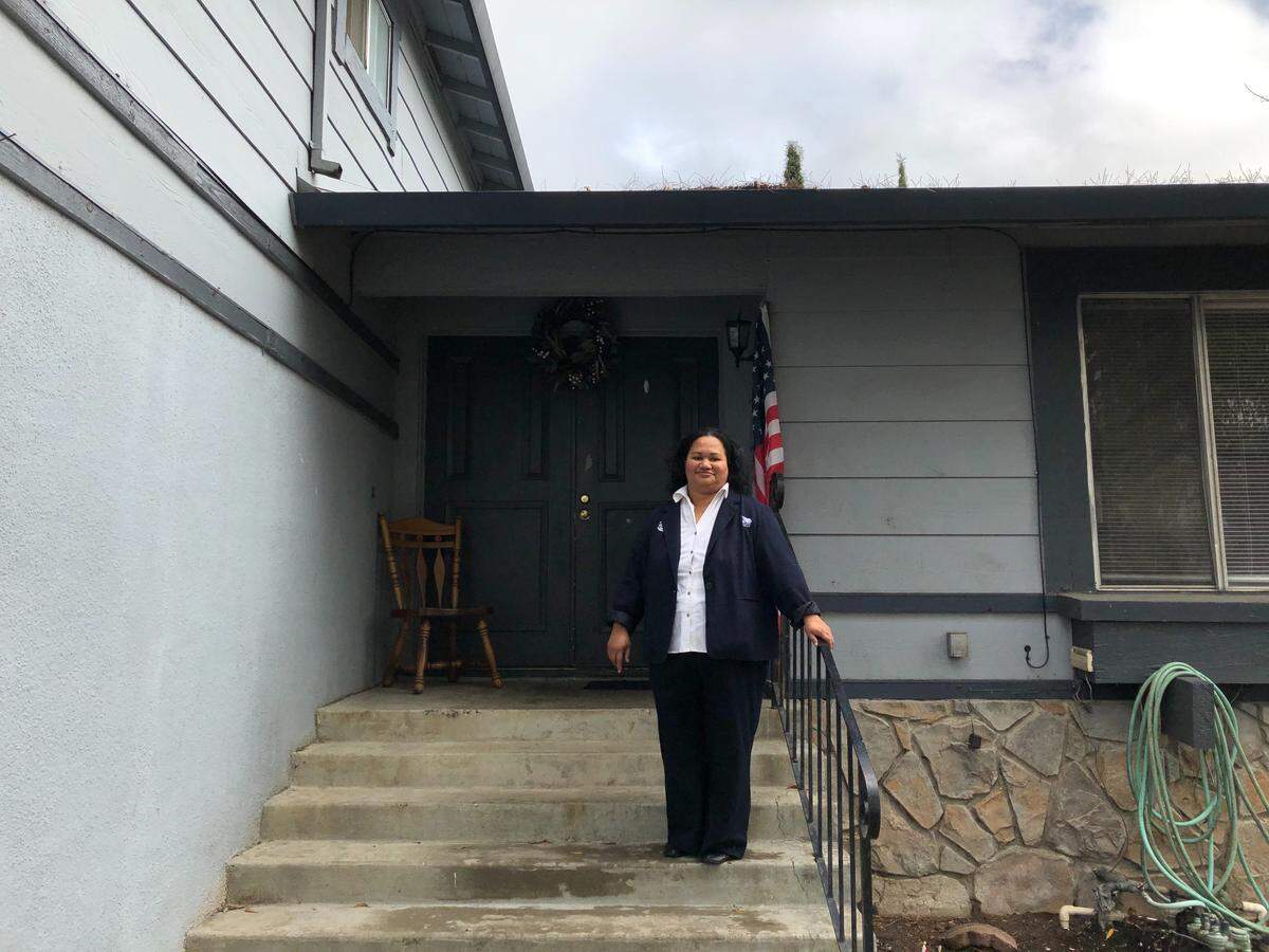 Puna Folau Makihele stands at the front door of her Room and Board that began its operations recently in South Sacramento.