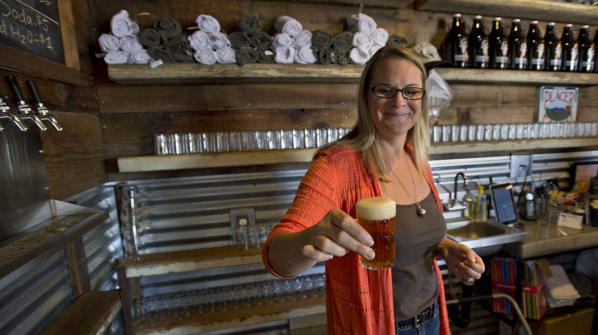 FILE -- Brewery owner Cathy Johnson with a sample of beer in the tasting room at the GoatHouse Brewery in Lincoln on Thursday, October 30, 2014. The brewery/farm, owned by Michael and Cathy Johnson, won a Brewers Association award, announced Tuesday, April 10, 2018.