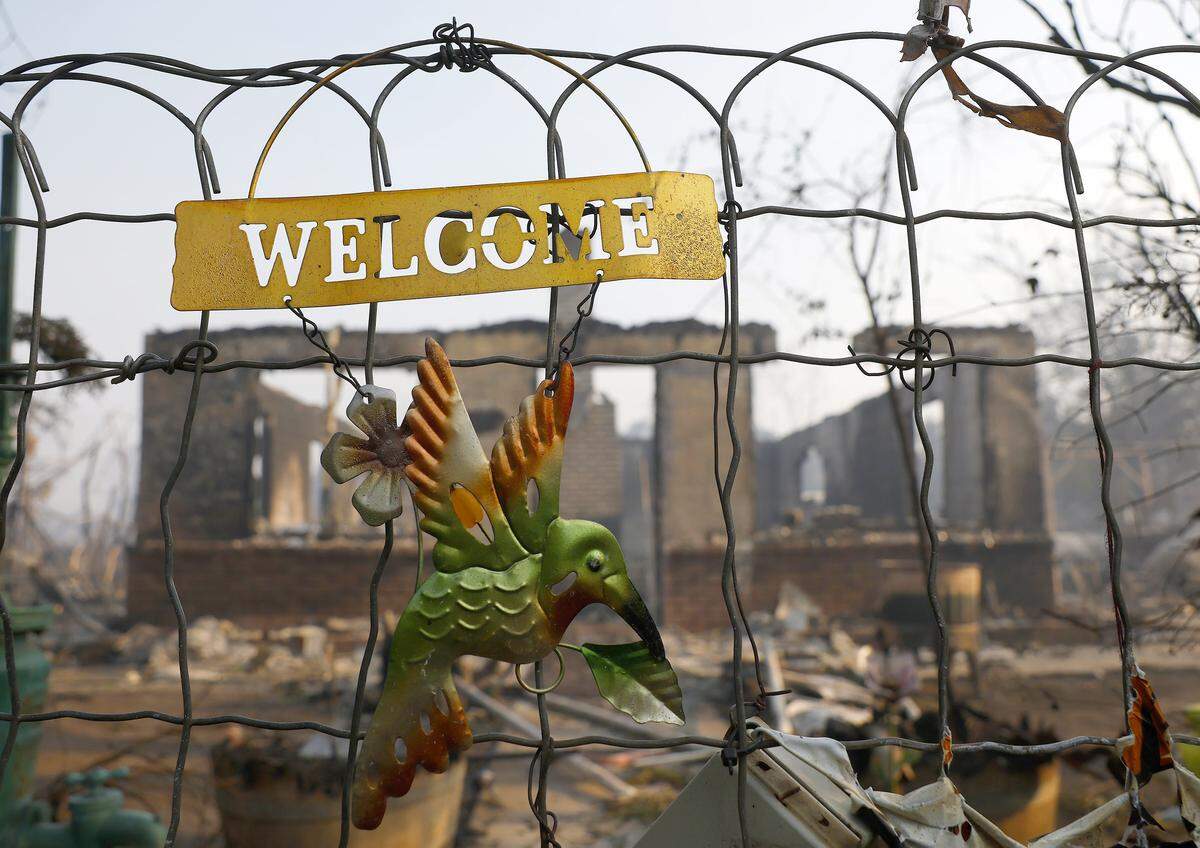 A welcome sign remains Wednesday on a gate in front of a property that was burned by the 6-5 Fire in the TCU September Lightning Complex in Chinese Camp. Nearly 12,000 acres have burned, and several structures were destroyed in the historic Gold Rush town.