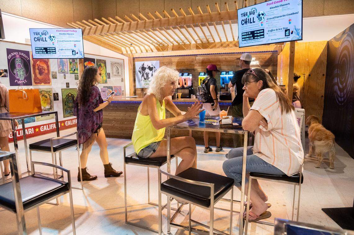 Victoria Derr, center, has a blue raspberry slushie with her friend on Tuesday inside the California Cannabis Exhibit during the California State Fair in Sacramento. The Big Chill sold slushies infused with cannabidiol, commonly referred to as CBD.