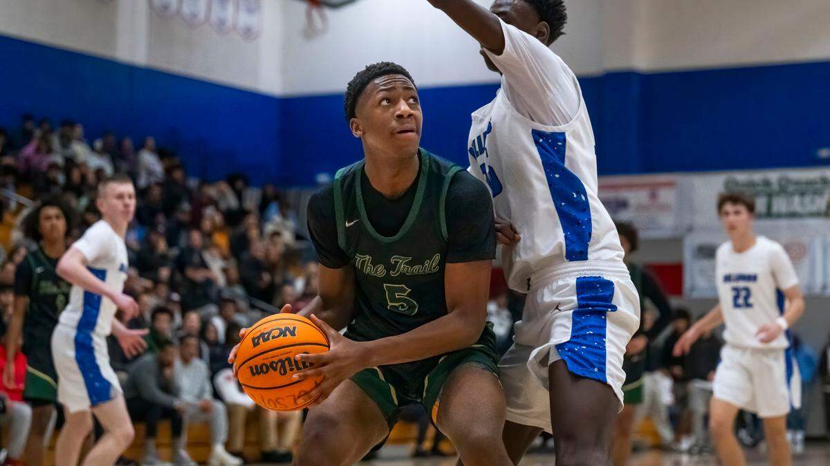 The Monterey Trail Mustangs’ Devaughn Dorrough (5) prepares to shoot as the Folsom Bulldogs’ Siyahe Siaisiai (35) defends during a boys basketball game in Folsom on Saturday.