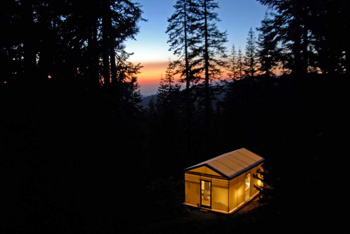 A tent cabin at Sequoia High Sierra Camp is lit up at night.