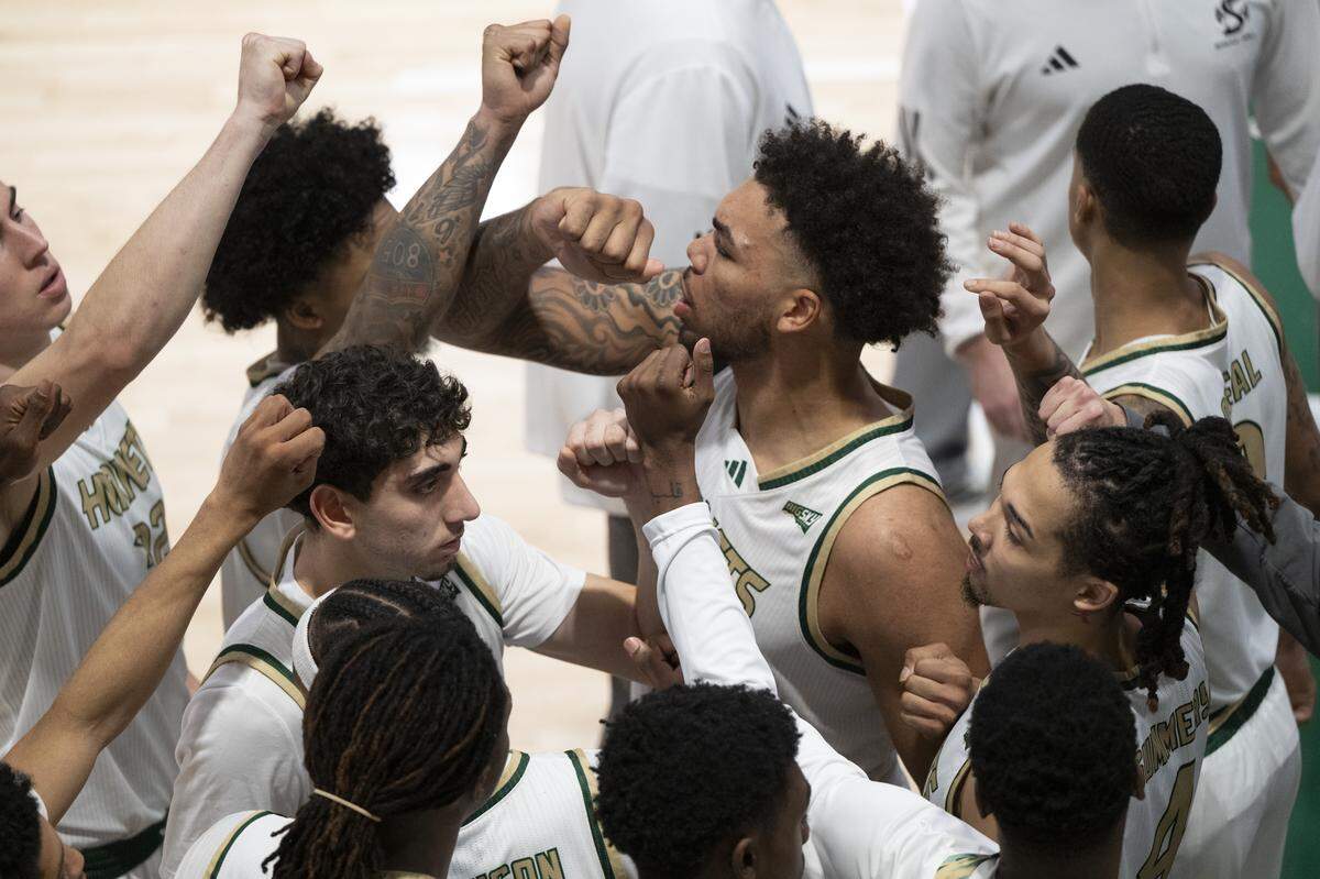 Sacramento State players fist bump after a time out during a game between Sac State and Presbyterian at Hornet Pavilion in Sacramento on Sunday, Nov. 16, 2025.