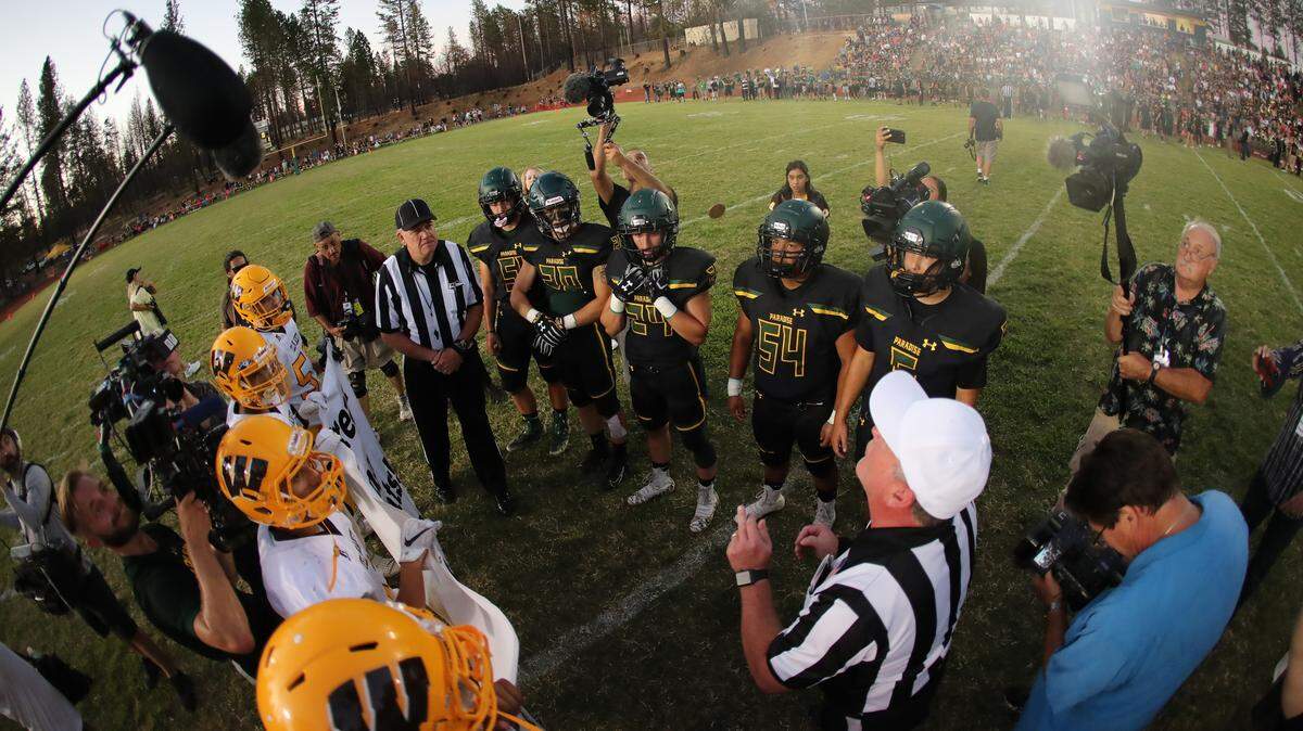 Paradise High football players, right, wore new helmets for their season opener. The caps were donated by Green Bay Packers quarterback Aaron Rodgers, a Pleasant Valley, of Chico, graduate.