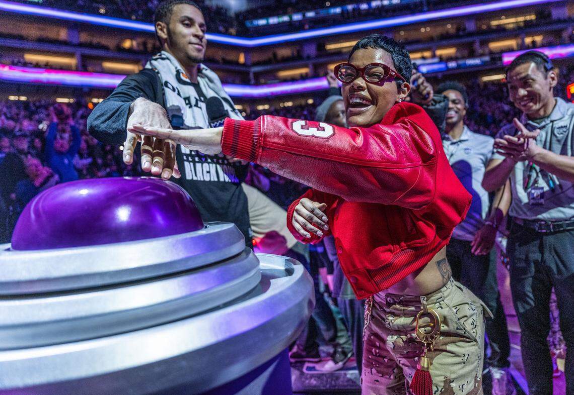 Actor-singer-songwriter Teyana Taylor lights the beam for the Sacramento Kings with forward Keegan Murray (13) after the team defeated the defending NBA champion Denver Nuggets in February 2024. Taylor was in Sacramento to film “One Battle After Another.”