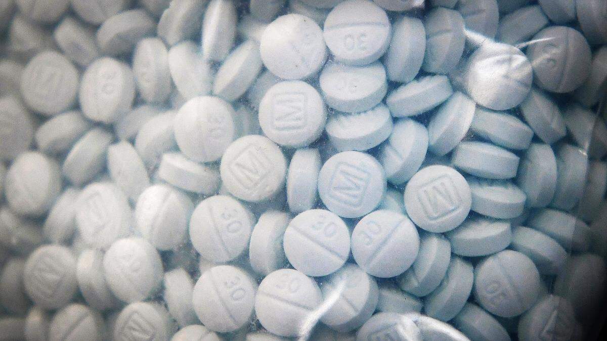 A bag of evidence containing the synthetic opioid fentanyl disguised as Oxycodone is shown during a press conference at the Fresno County Sheriff’s Office in 2020. Opioid users sometimes unintentionally overdose after unknowingly ingesting fentanyl, which dealers cut into other drugs because it is cheap and potent.