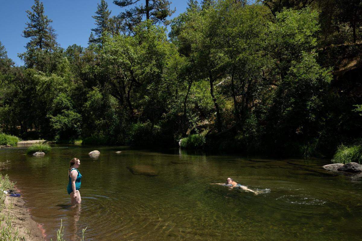 Kimberly Petree, executive director of Cosumnes Culture and WaterWays and a descendent of a Miwok tribe that lived in the area, and her step daughter Kassy Speck swim in the north fork of the Cosumnes River on Friday, July 18, 2025.