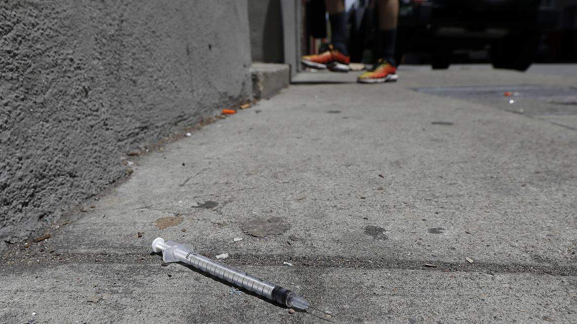 A used syringe is shown on a sidewalk in San Francisco in May. A downtown restaurant is tweaking the city over a policy that hands out millions of syringes a year to drug users and an upcoming ban on plastic straws in restaurants.