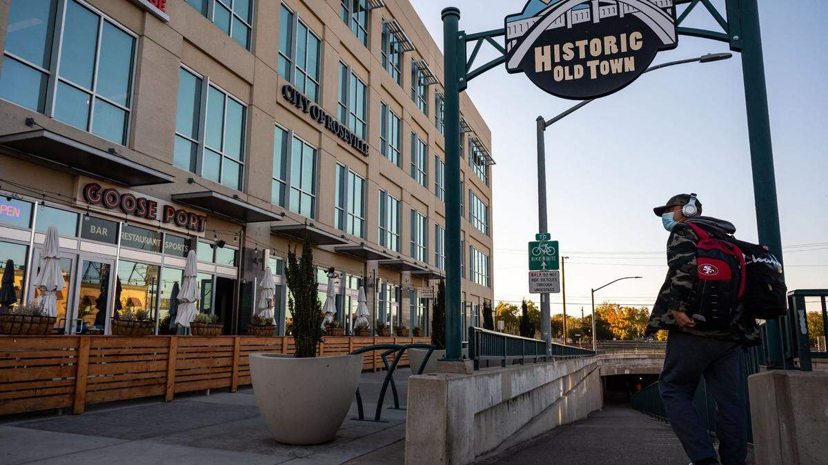Robert Nichols, who was born in Roseville and grew up in Lincoln, turns on the Washington Avenue walkway under the railroad tracks on his way to the Greyhound station on Wednesday, Oct. 13, 2021. Roseville recently removed outdoor dining decks from downtown.