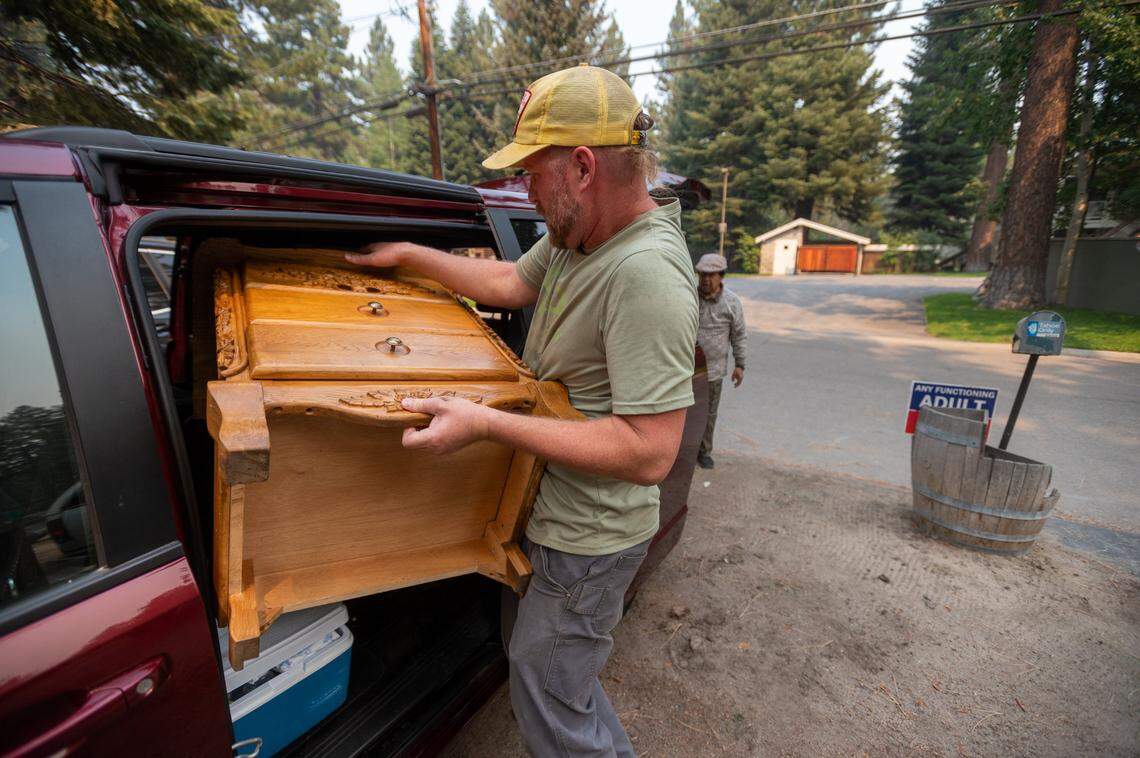 D.J. Evans packs up his home with girlfriend Karlyn Malicdem as they prepare to evacuate South Lake Tahoe as the Caldor Fire burns toward the city on Monday.