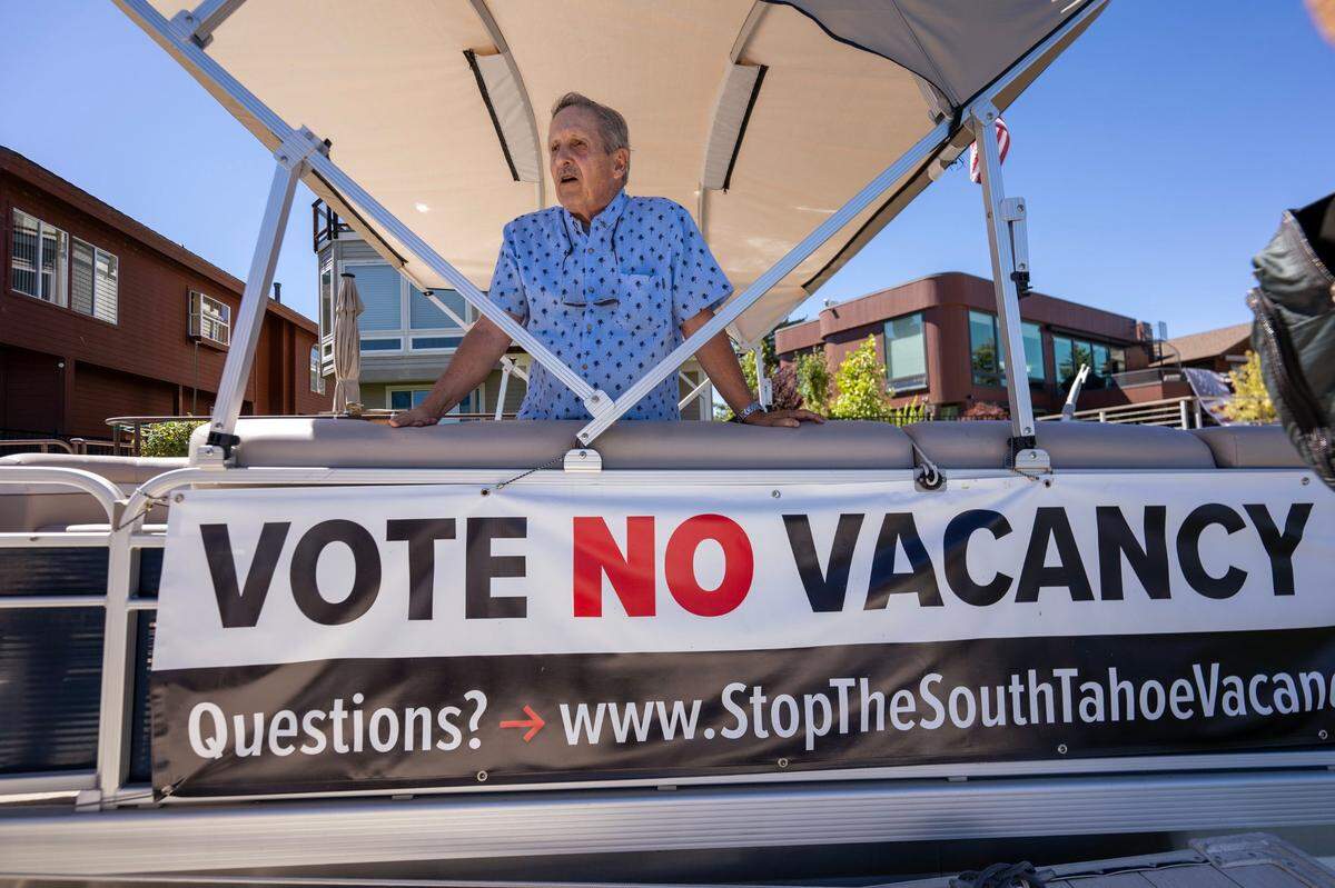 A “vote no vacancy tax” poster hangs on Tom Spencer’s boat in Lake Tahoe in August. Spencer, owner of two properties in the area, says the proposed tax on vacant homes is unfair.
