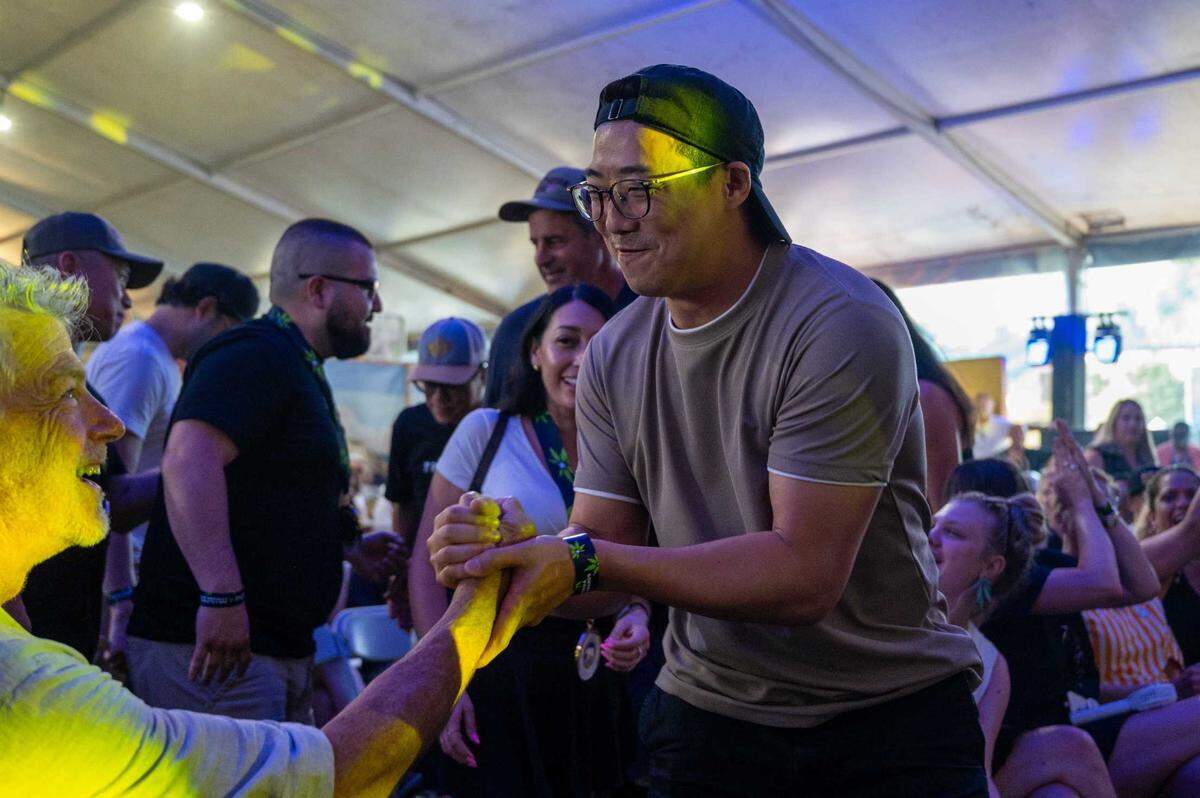 Ay Papi founder Justin Lee, right, shakes hands with James Leitz before receiving a Golden Bear award at the California Cannabis Awards at the California State Fair on Saturday.