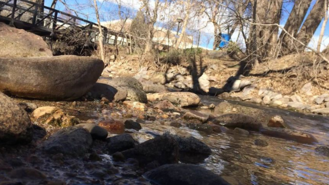 A woman died after being rescued from a Colorado creek near where she was camping, officials said.