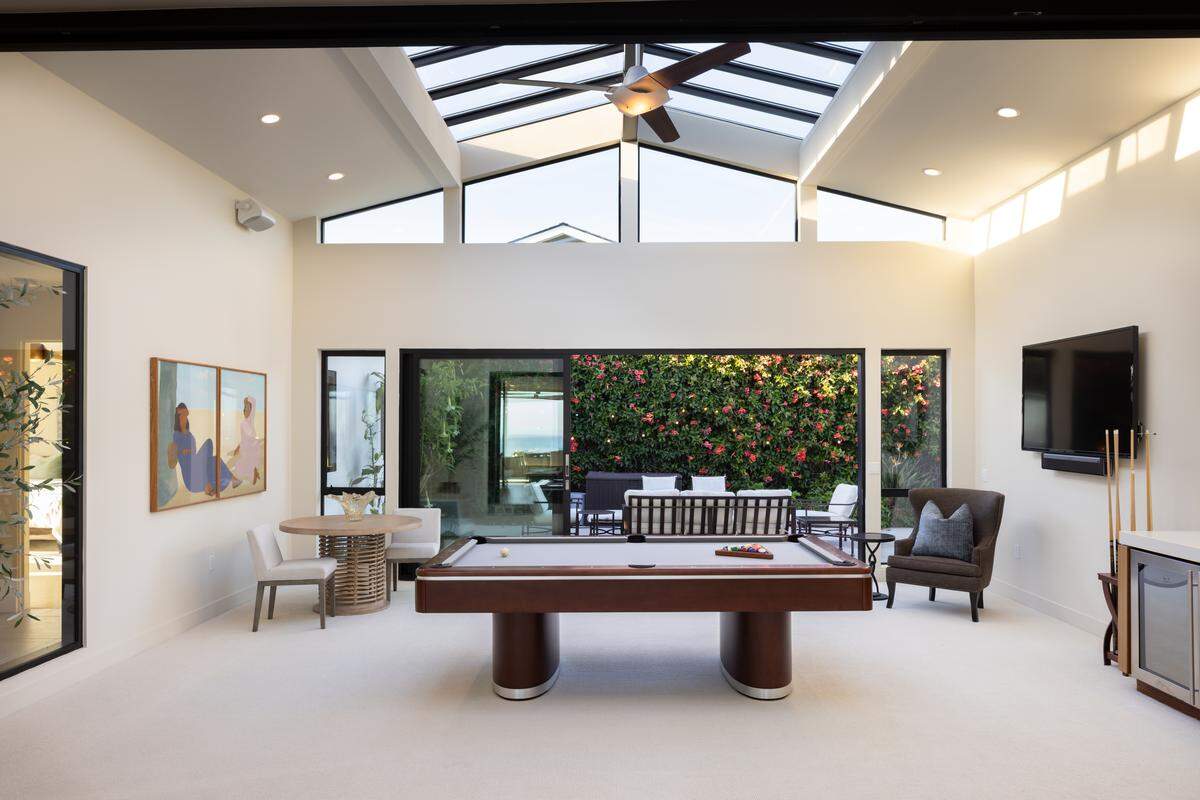 An atrium-style game room, oceanview hot tub and surf-facing sun patio are a few of the amenities of the Santa Cruz, California house.