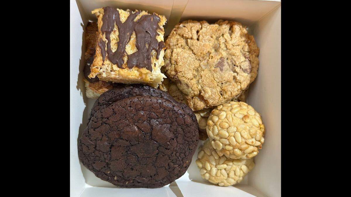 Clockwise from top right: Hannah Holzer’s kitchen sink cookies, pignoli, chocolate hazelnut cookies and coconut macaroon bars.