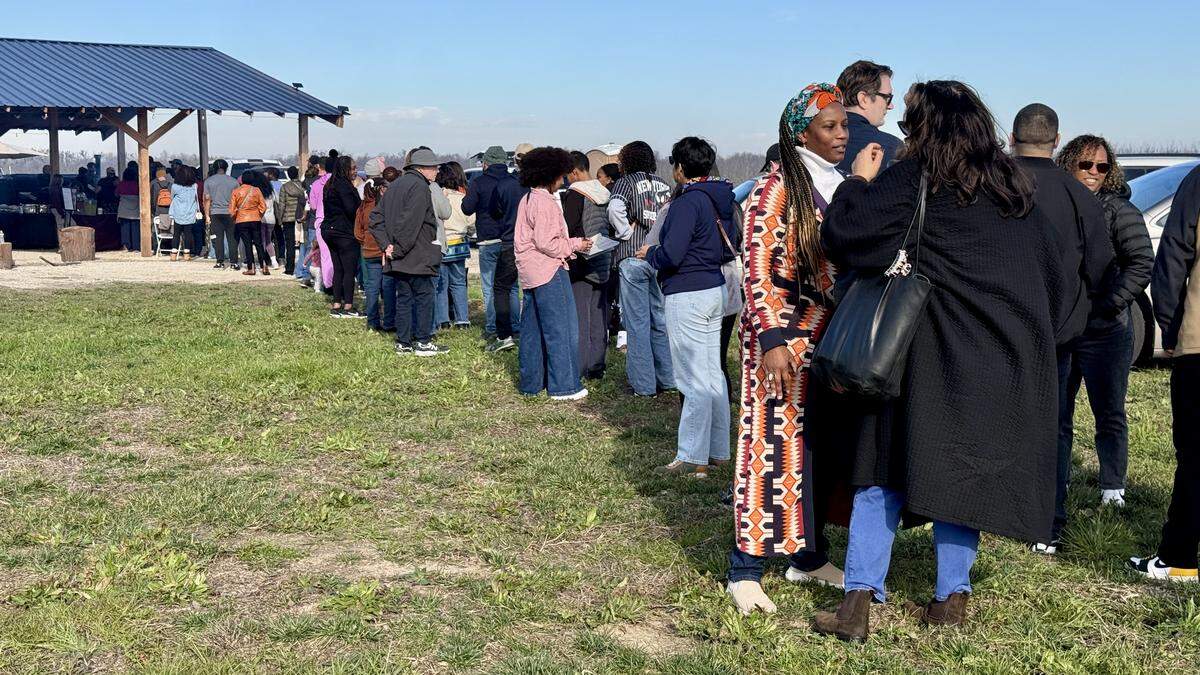 Dozens of hopeful diners wait in line for The Village’s Taste of East Africa event. Esther Mmbando — one half of the founding couple for the farm — said the line held steady through the end of the event.