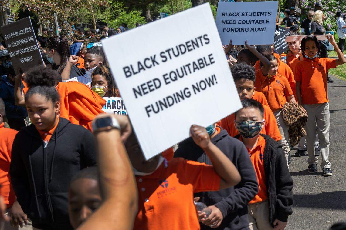 Students hold signs on Tuesday, April 11, 2023, at a Black in School Coalition rally and march at Capitol Park in Sacramento in opposition to Gov. Gavin Newsom’s education budget proposal, which they said doesn’t provide enough funding to narrow the academic achievement gap for Black students.